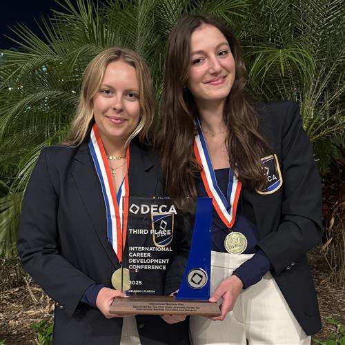  DECA students with trophy